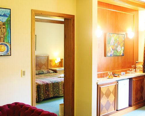 A well equipped kitchen alongside a bedroom.