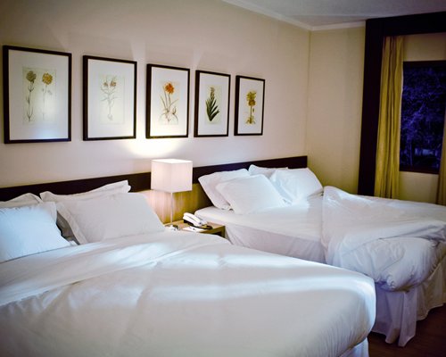 A well furnished bedroom with two queen beds.