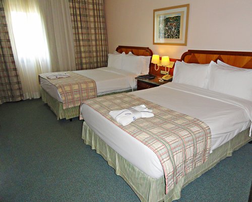 A well furnished bedroom with two beds.