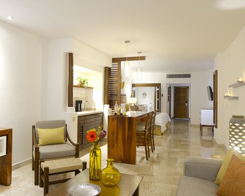 A well furnished living room with an open plan kitchen and dining area.