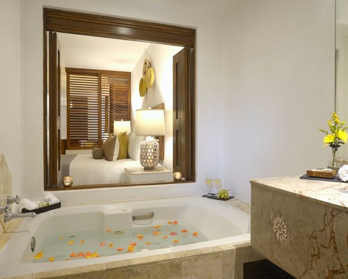 A bathtub alongside bedroom.