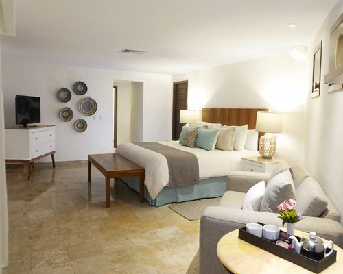 A well furnished bedroom with a television.