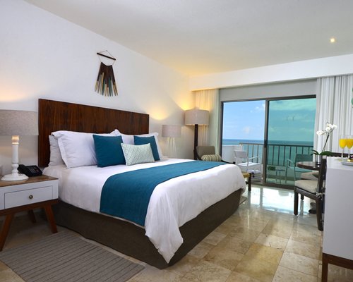 A well furnished bedroom with a balcony.