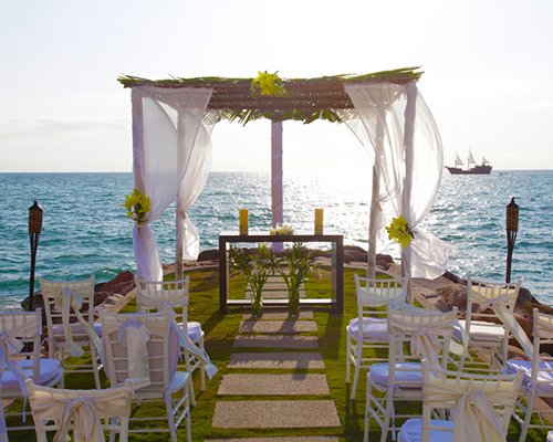 An outdoor wedding altar alongside the ocean.