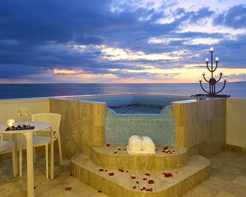 Rooftop private dining area and hot tub with ocean view.