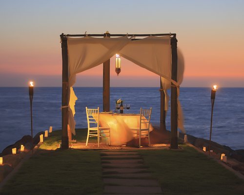 Pathway to an outdoor private dining area alongside the ocean.