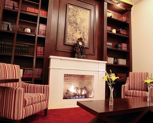 A well furnished living room with a fire in the fireplace.