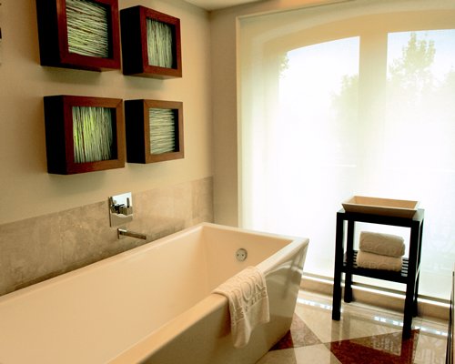 A bathroom with shower and bathtub.