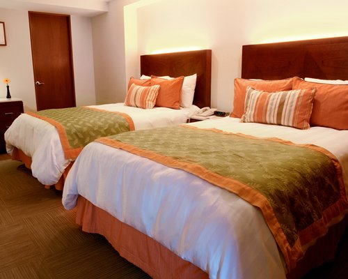A well furnished bedroom with two twin beds.