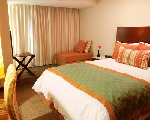 A well furnished bedroom with a king bed.