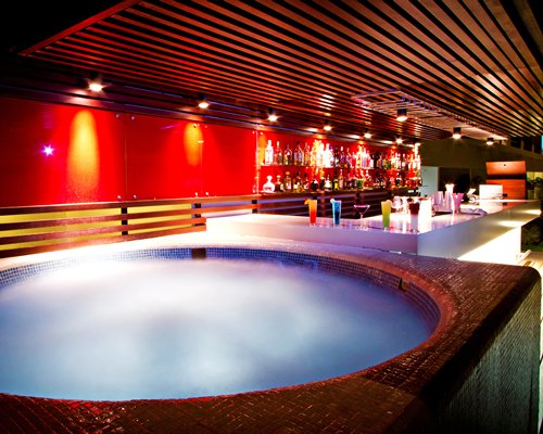 A well equipped indoor bar with a hot tub.