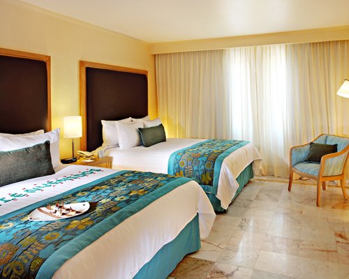 A well furnished bedroom with two beds.