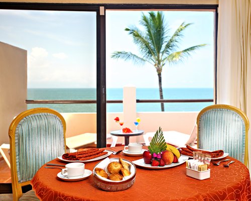 A well furnished dining area with a balcony.