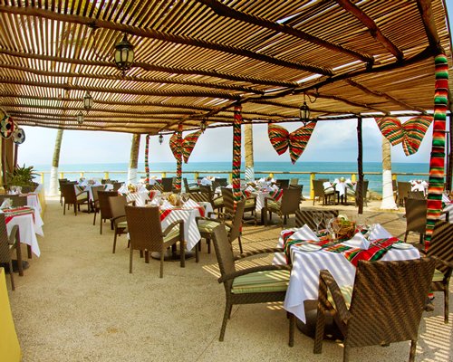 A well furnished indoor fine dining restaurant alongside the ocean.