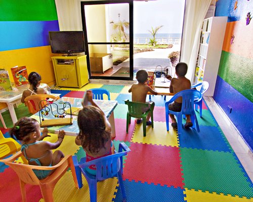View of kids in an indoor recreational room with a television.