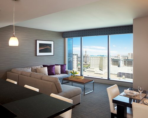 A well furnished bedroom with pull out sofa and outside view.