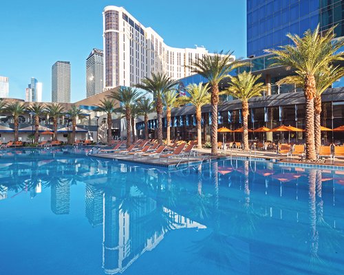 An outdoor swimming pool with chaise lounge chairs.