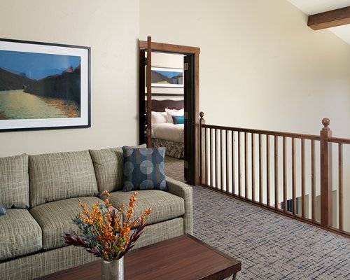 A well furnished bedroom with a balcony and patio furniture.