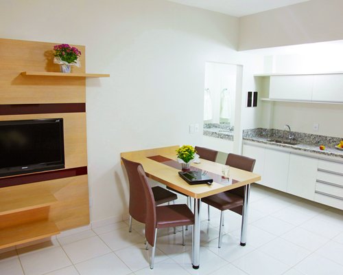 A well furnished dining room with a television.