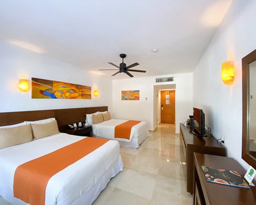 A well furnished bedroom with two beds and an outside view.