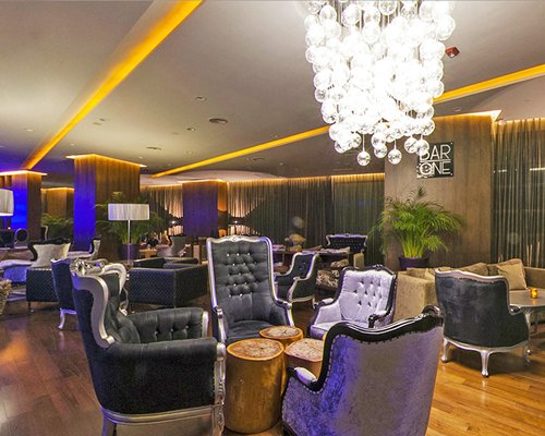 Interior of Bar One with a chandelier at Sandos Cancun Luxury Experience Resort.