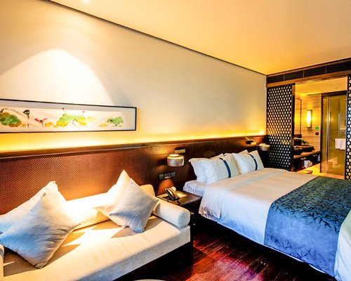 A well furnished bedroom with king bed and bathroom.