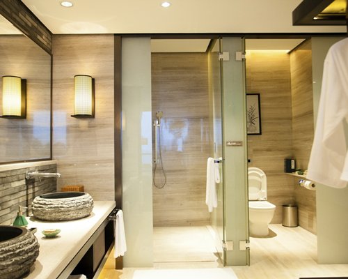 A bathroom with shower stall and double sink vanity.