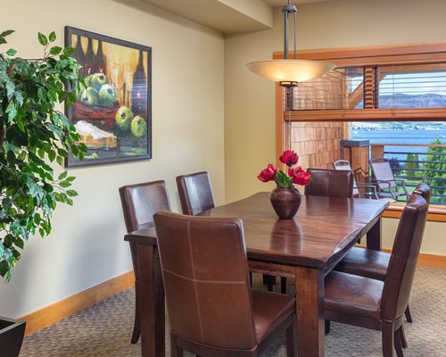 A well furnished dining room with a balcony.