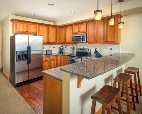 A well equipped kitchen and breakfast bar.
