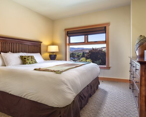 A well furnished bedroom with an outside view.