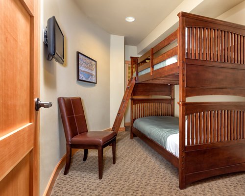 A well furnished bedroom with bunk beds.