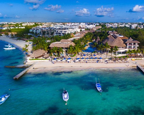 An aerial view of The Reef Cocobeach with an outdoor swimming pool alongside the beach.