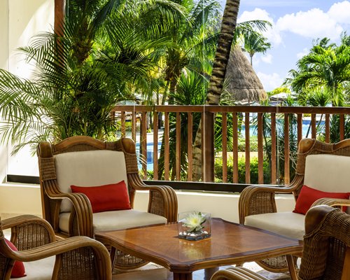 Balcony with patio furniture and outside view.
