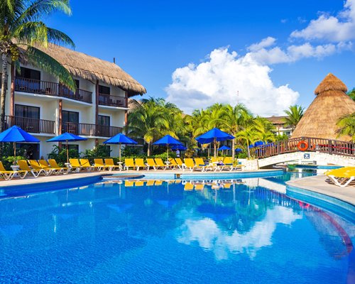 Large swimming pool with ample shaded lounge seating.