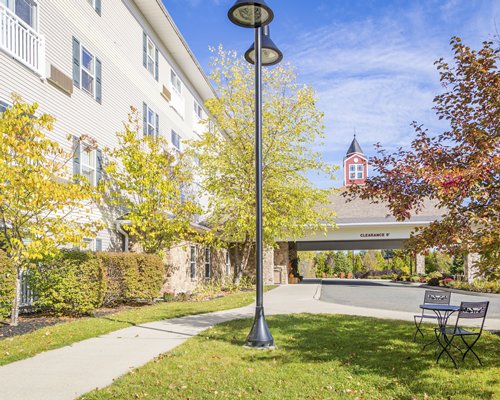 An exterior view of multi story resort unit with trees.