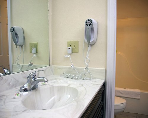 A bathroom with an open sink vanity.