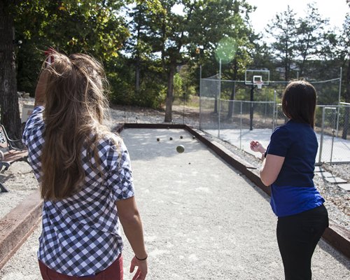 View of two women playing lawn ball.