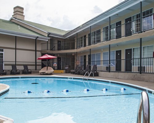 An outdoor swimming pool with chaise lounge chairs.