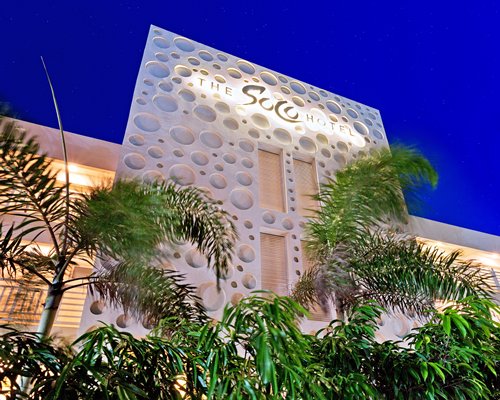 Ground view of the SOCO Hotel at night.