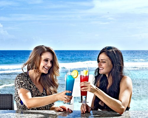 View of two women drinking cocktails.