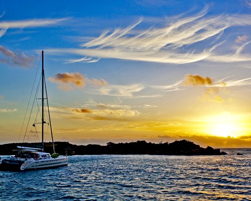 A catamaran on the ocean at dusk.