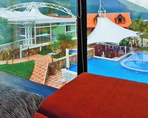 An outdoor swimming pool alongside resort units.