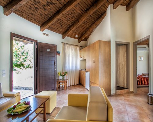 A well furnished living room with bedroom and outdoor view.