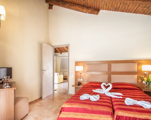 A well furnished bedroom with a television.