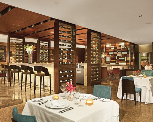 A well equipped indoor bar covered with wine rack.