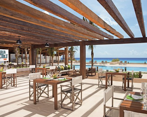 An outdoor fine dining restaurant overlooking the sea.