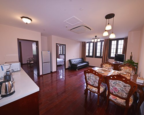 Living room with an open plan kitchen and dining table.