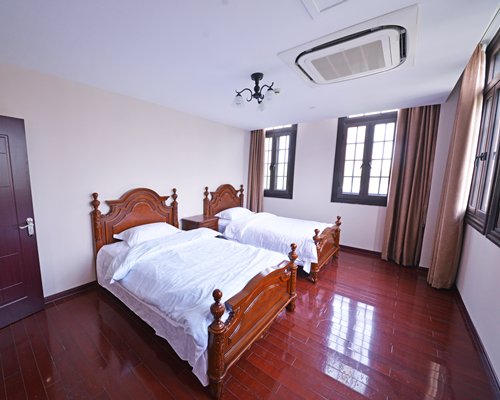 A well furnished bedroom with two beds.
