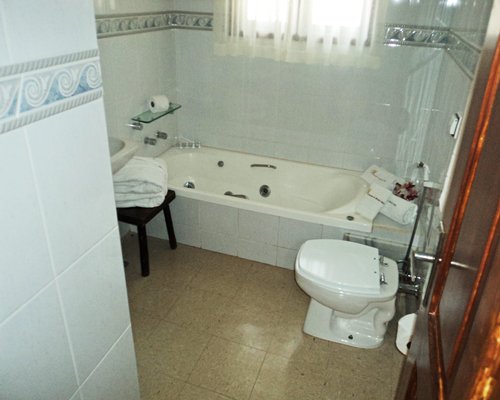 A bathroom with a bathtub and shower.