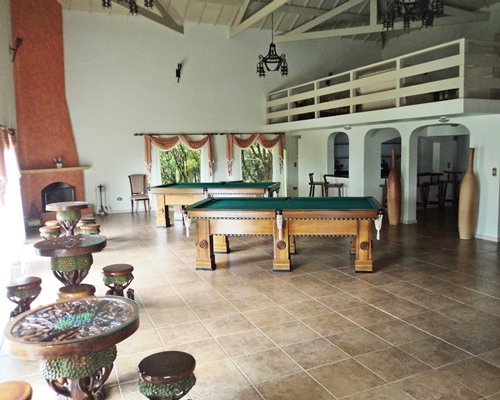 An indoor recreation room with pool tables.